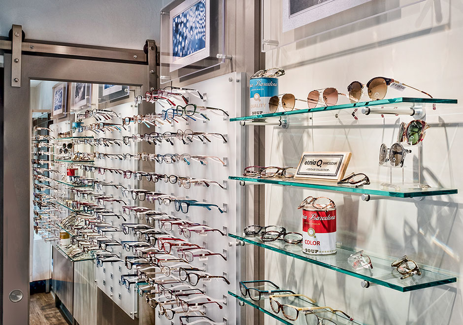 Wall of eye glasses display with sliding door in background